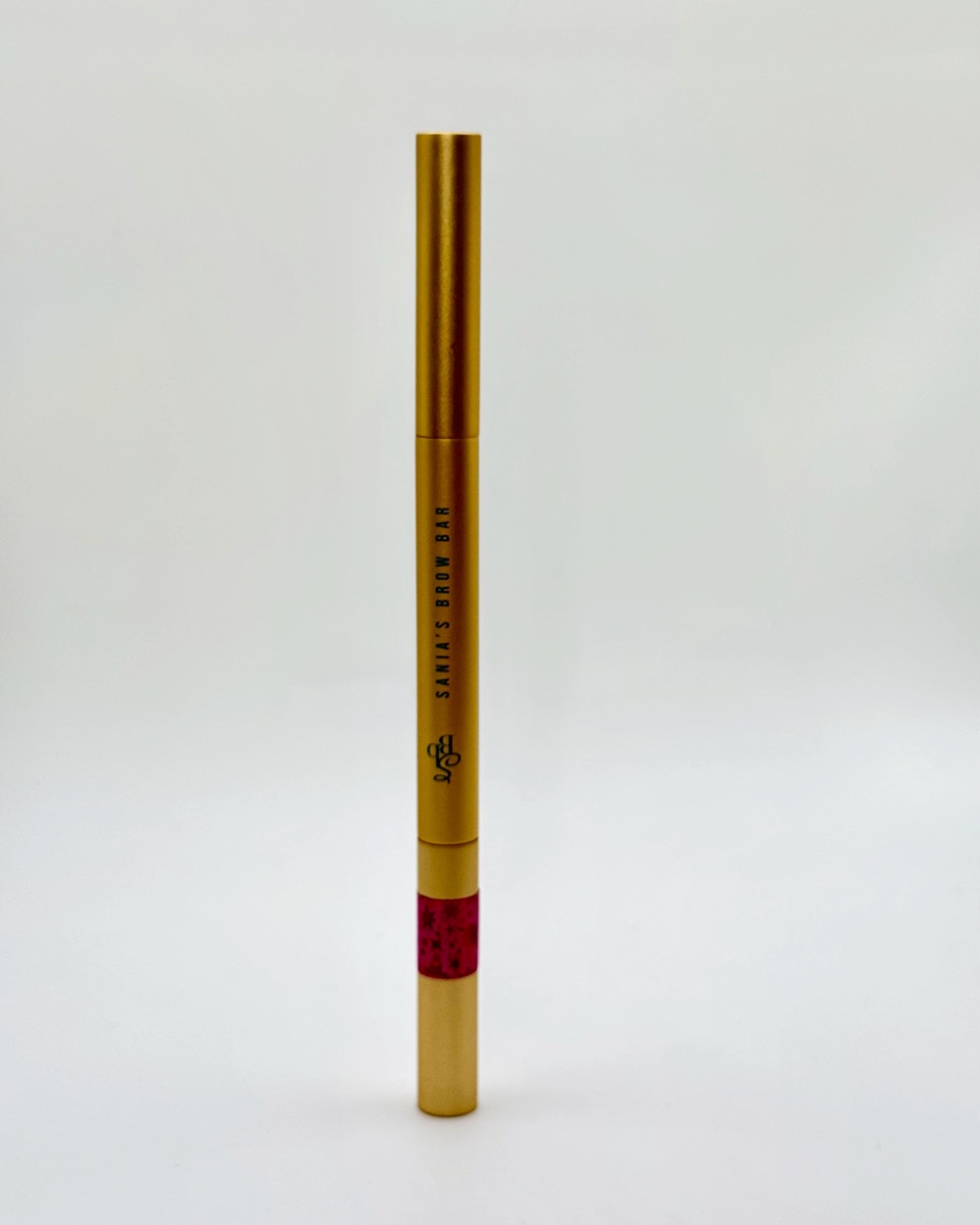 Gold Sania&rsquo;s Brow Bar brow pencil with a band of sparkly pink tape